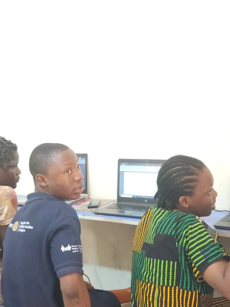 HCS students learning computer basics side by side