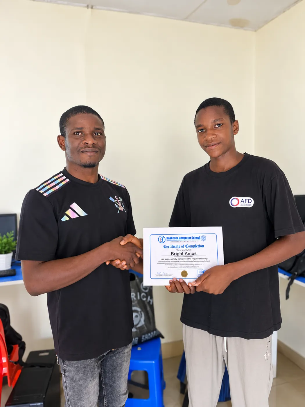 HaskeTek Computer School graduate Bright Amos receiving his Certificate of Completion